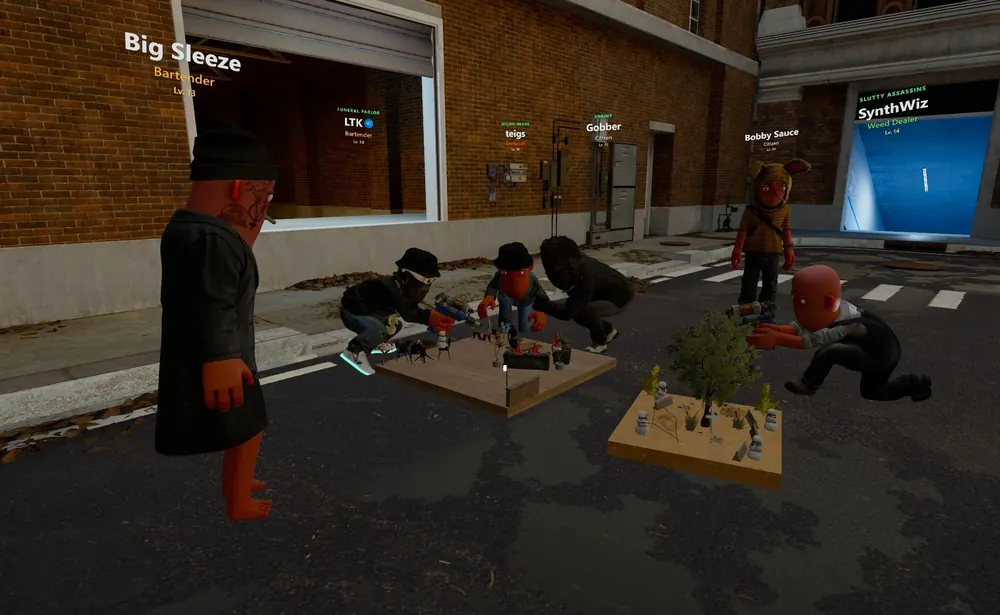 Players crouch around miniature builds laid out for sale on the street
